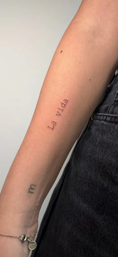 Tatuaje de la frase «La vida» en letra de máquina de escribir
